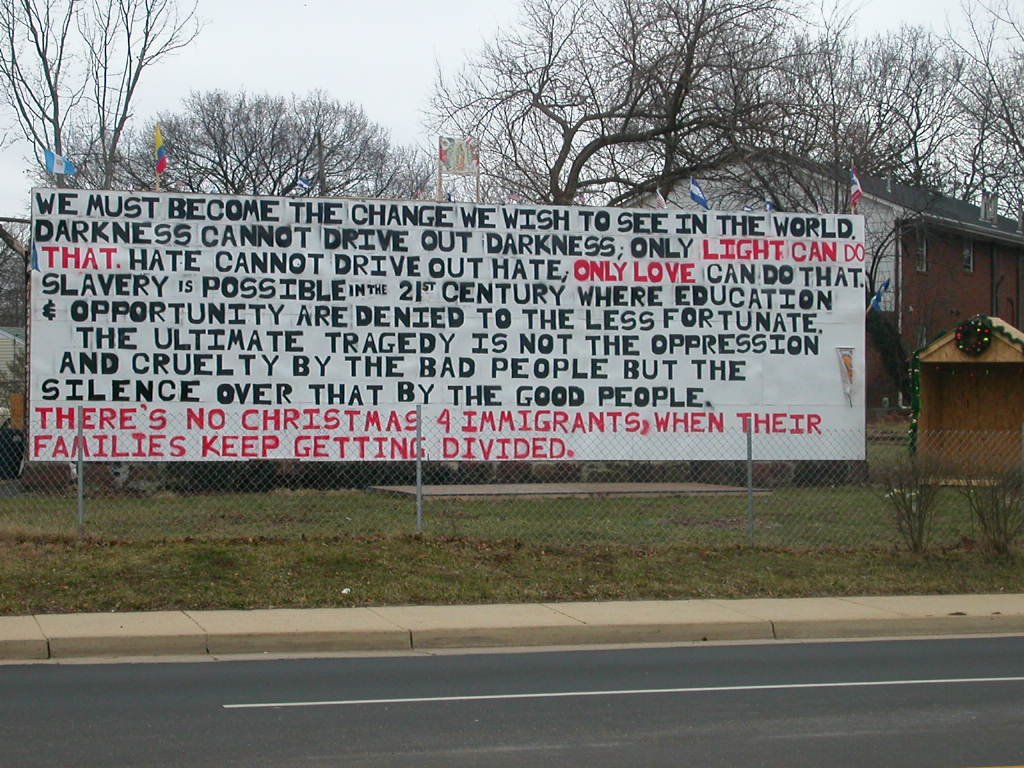 sign across from Manassas Railroad depot supporting Hispanic immigrants