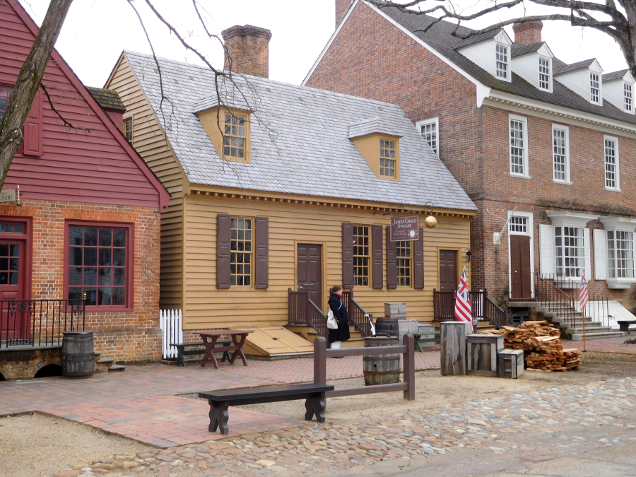 Colonial Williamsburg places a flag outside restored structures to indicate historic interpreters are available for interaction with the public at that particular site
