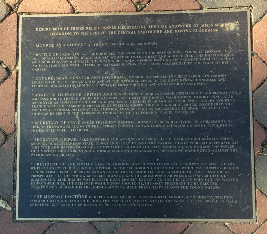 a plaque explains the friezes underneath the James Monroe statue at William and Mary