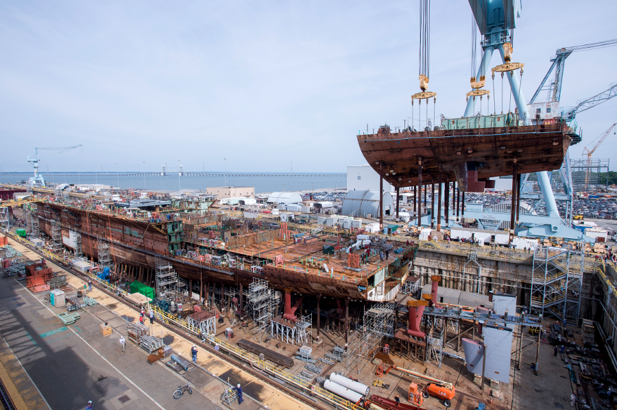 Huntington Ingalls Shipbuilding in Newport News attaches the lower stern to the rest of the hull of the nuclear-powered aircraft carrier USS John F. Kennedy